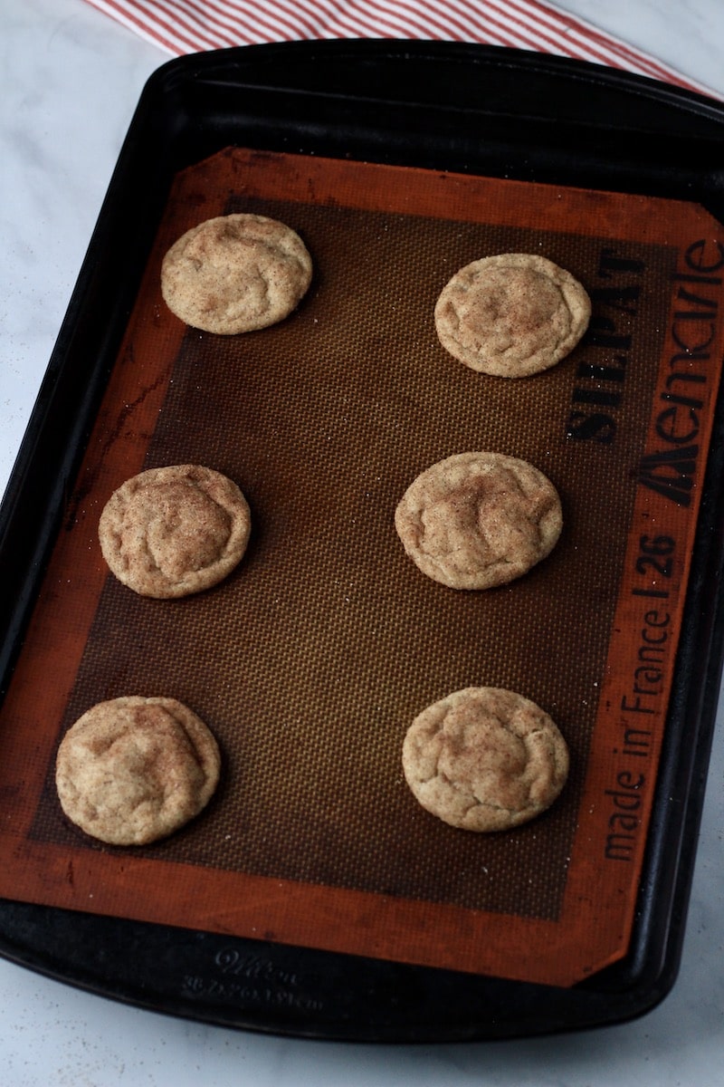 A cookie sheet with a silat and vegan cookies on top.