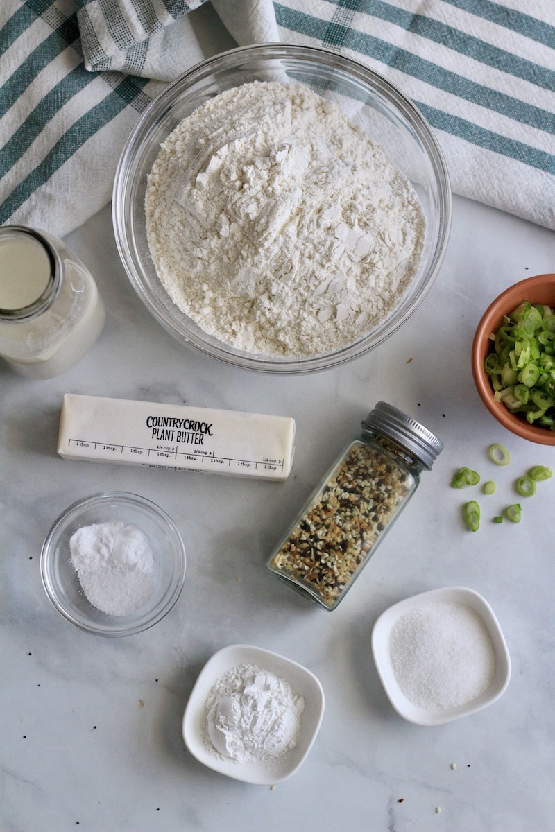 Ingredients for everything bagel scallion biscuits on a white counter.