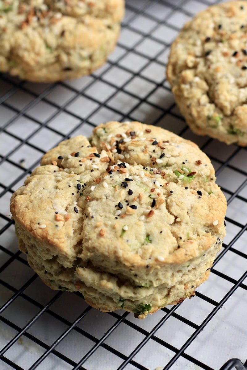 A close up of an everything bagel scallion biscuit on a cooling rack.