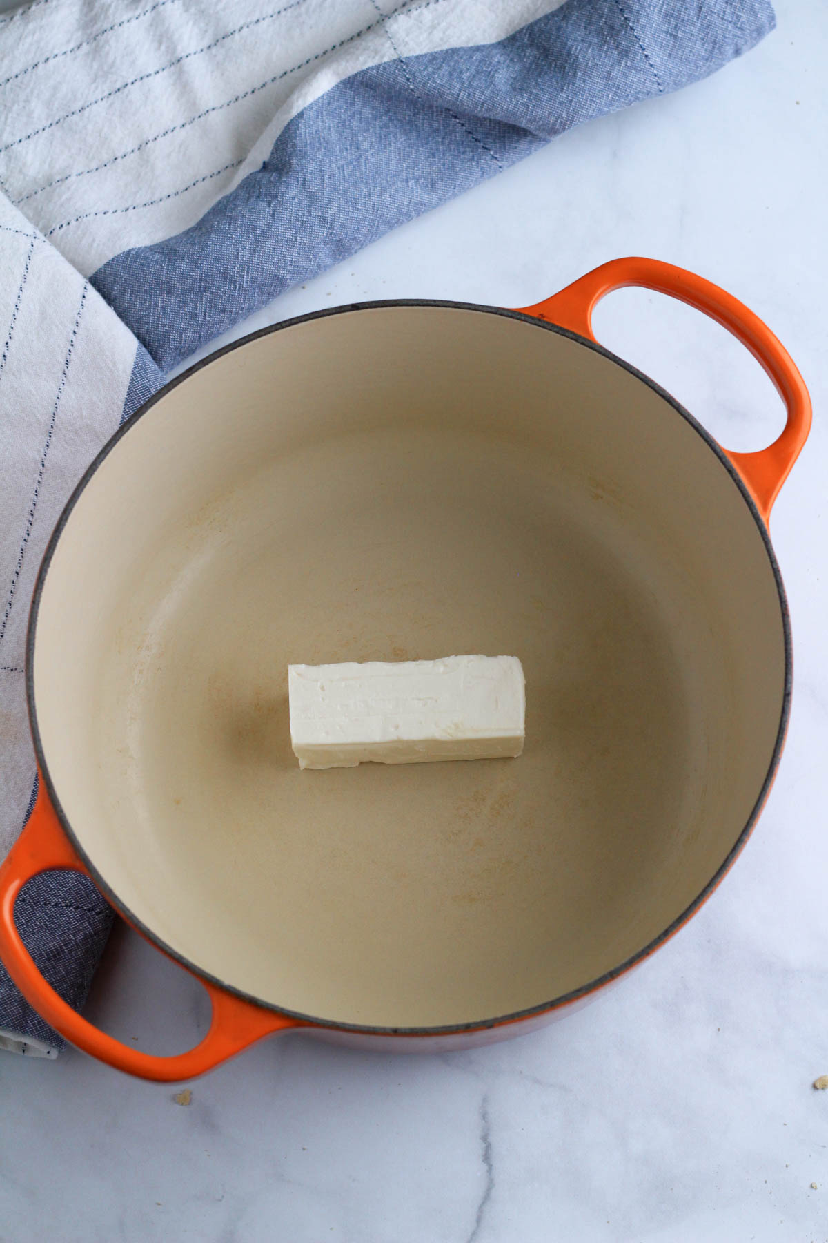 A large orange pot with 6 tablespoons of vegan butter.