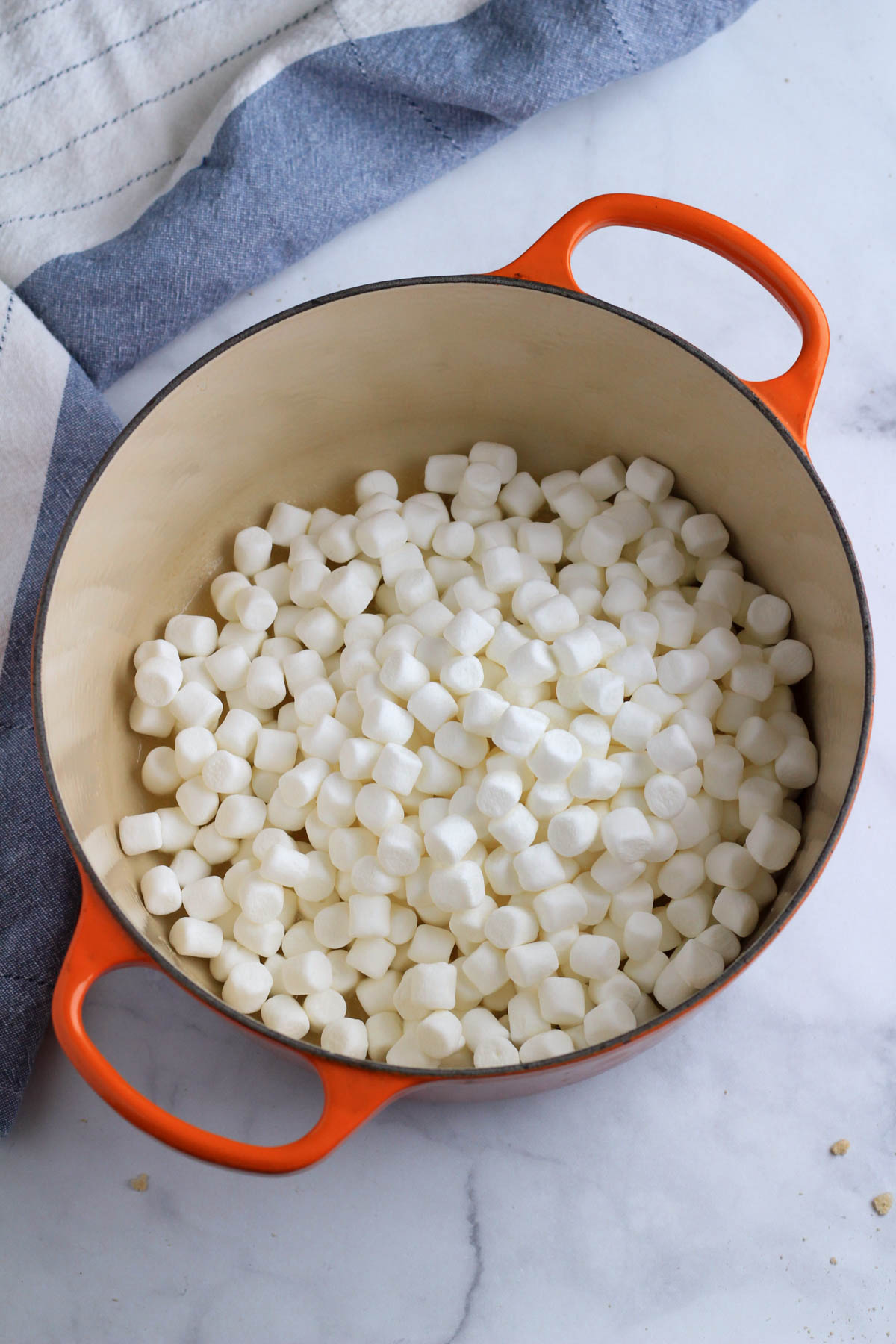 A large orange pot with mini marshmallows.