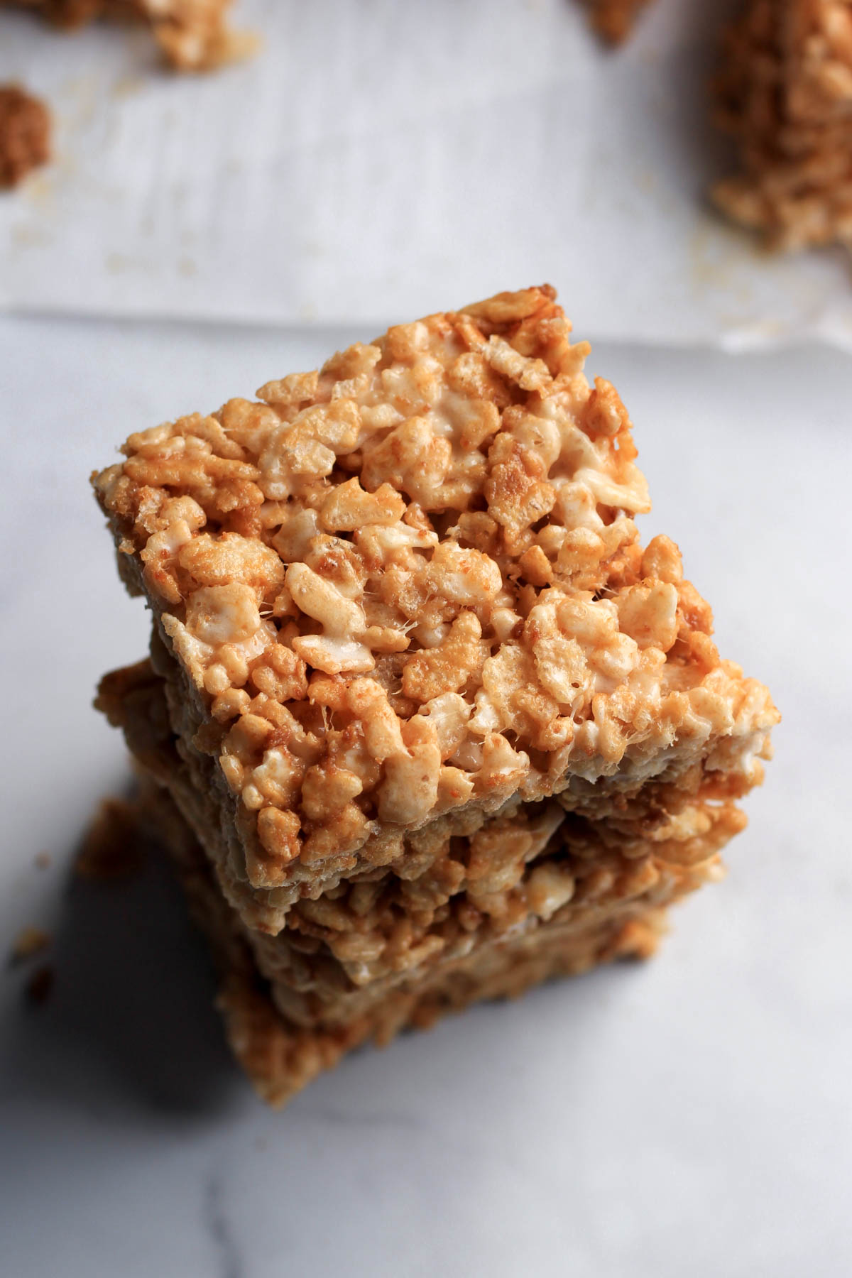 A stack of three cookie butter rice krispie treats on a counter.