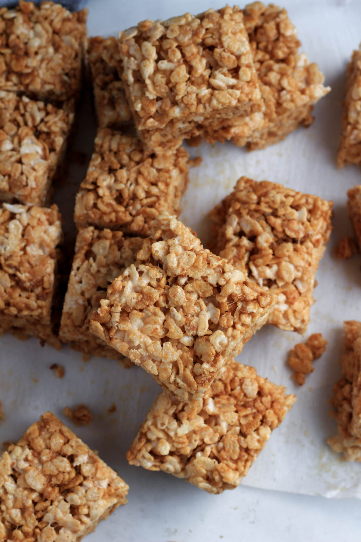 A pile of cookie butter rice krispie treats on parchment paper.