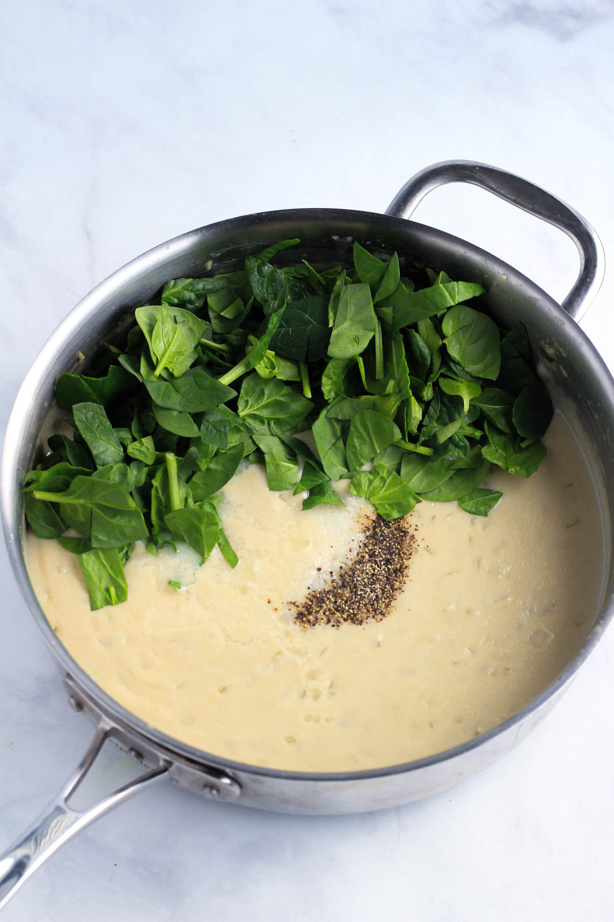 Spinach, salt, pepper, and lemon juice added to the cream sauce.