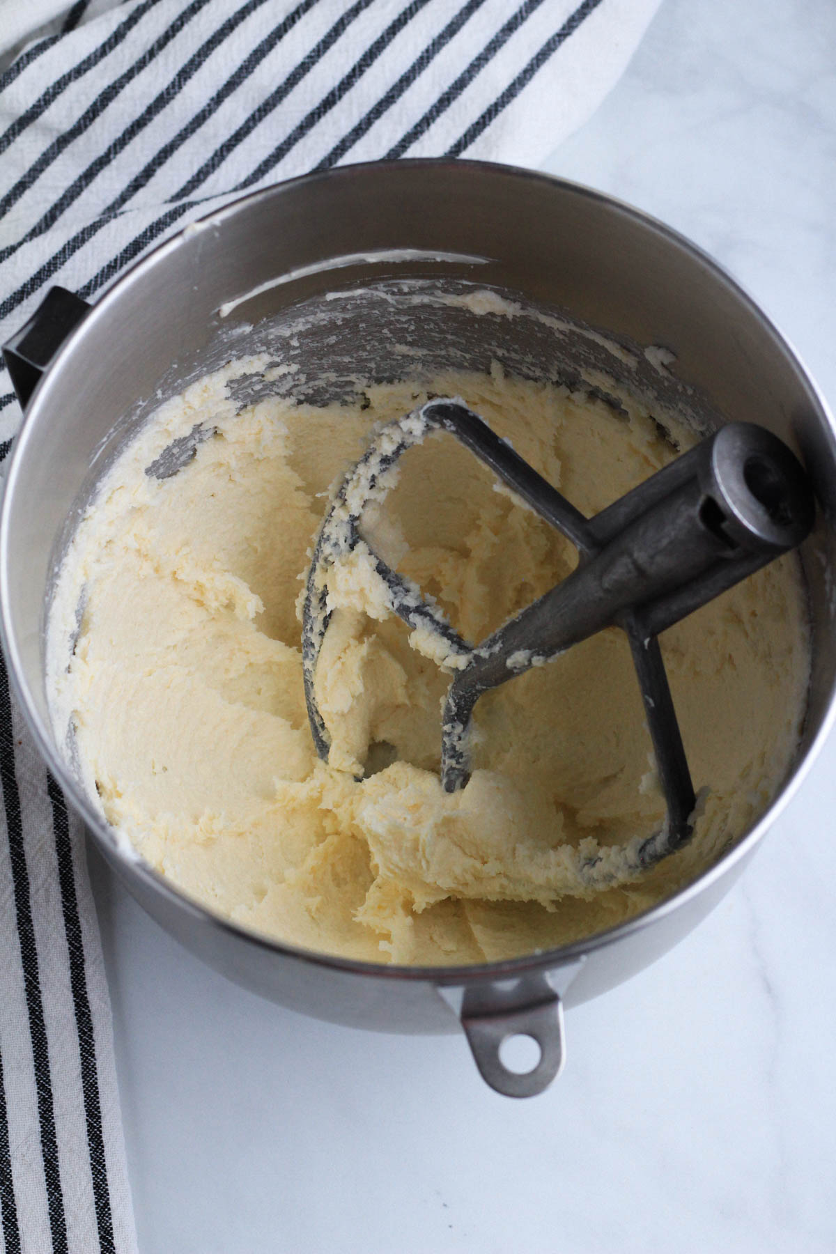 Creamed vegan butter and sugar in a mixing bowl.
