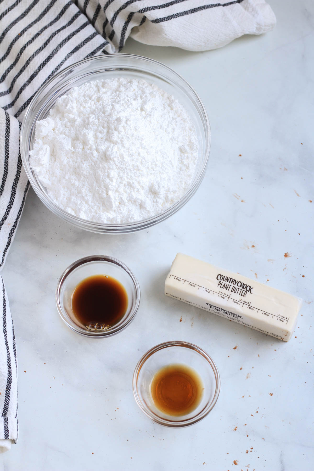 Ingredients for coffee buttercream frosting on a white counter.