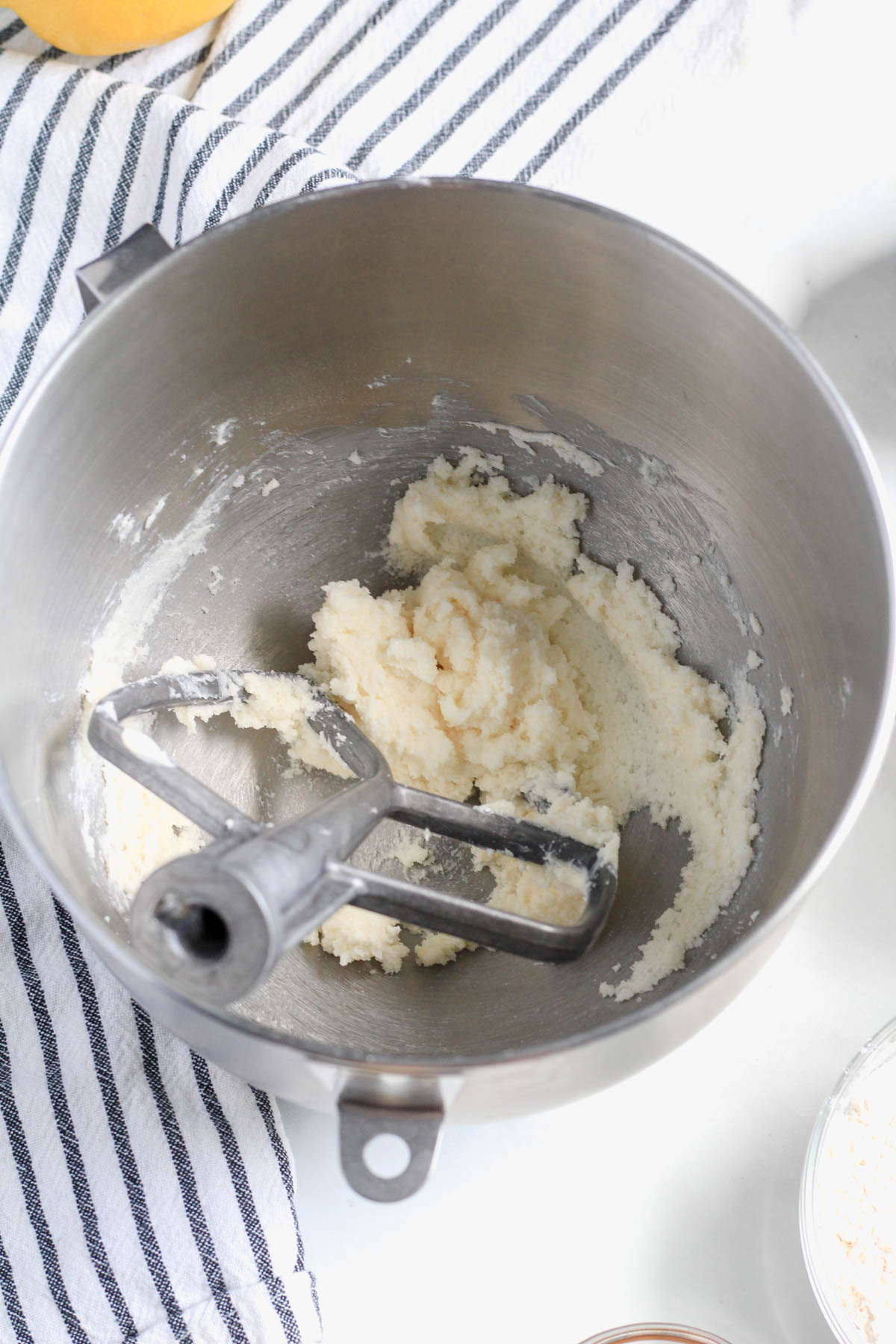 Dairy-free butter and sugar creamed in a mixing bowl with a paddle attachment.