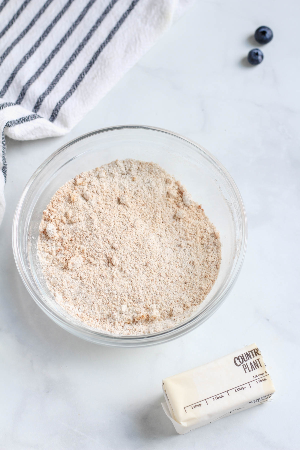 A small glass bowl with the ingredients for the topping mixed together before adding the plant-based butter.