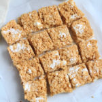 A parchment paper lined counter with sliced maple Rice Krispie treats.