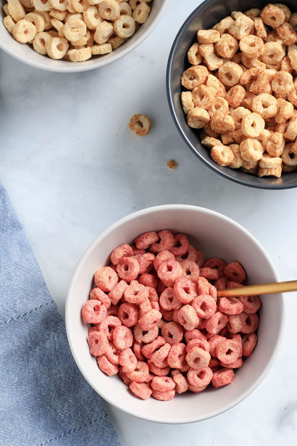 A top down picture of bowls of three wishes cereal with a bowl of fruity in the front and a bowl of cinnamon in the back right.