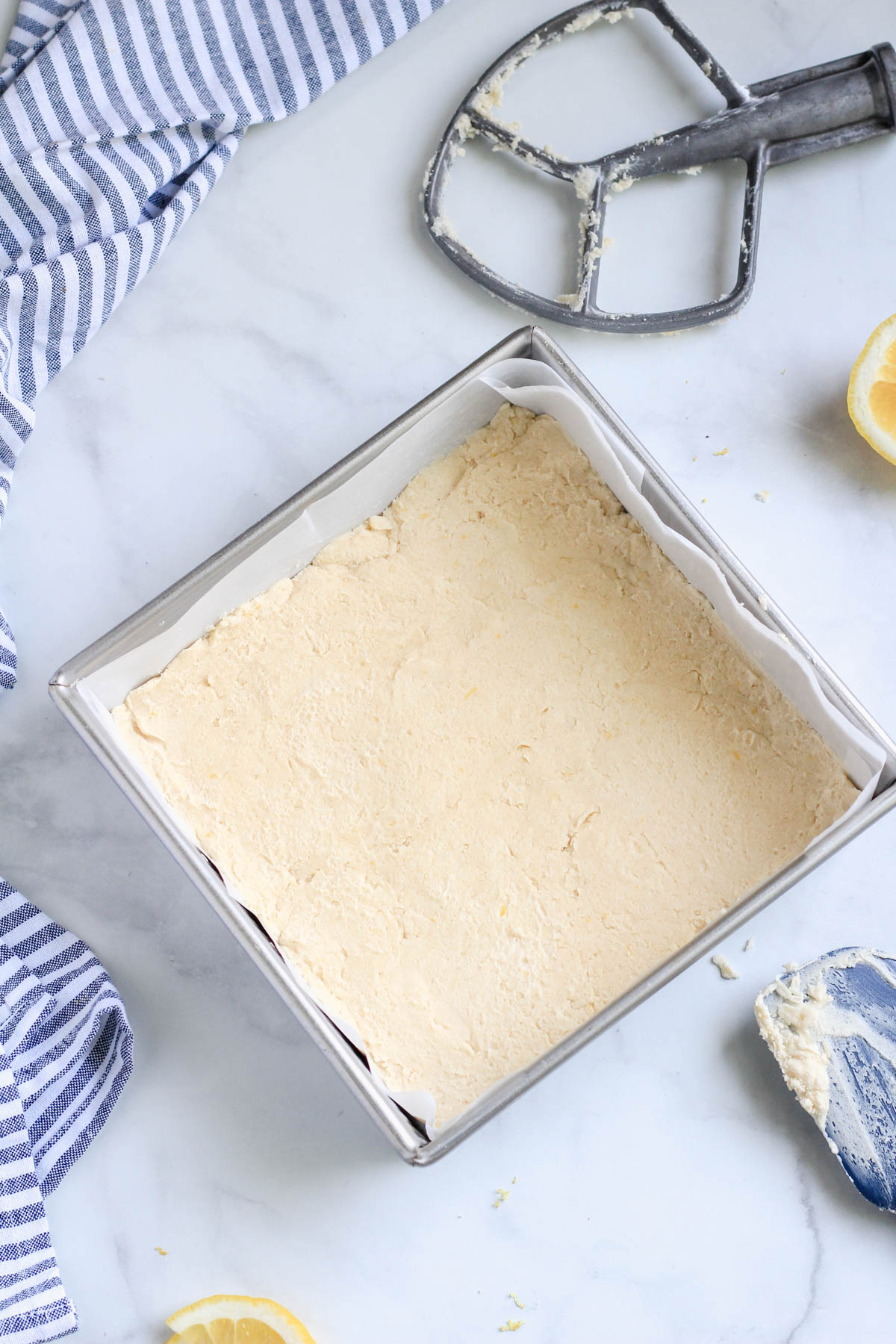 Vegan lemon shortbread pressed in a square baking pan.
