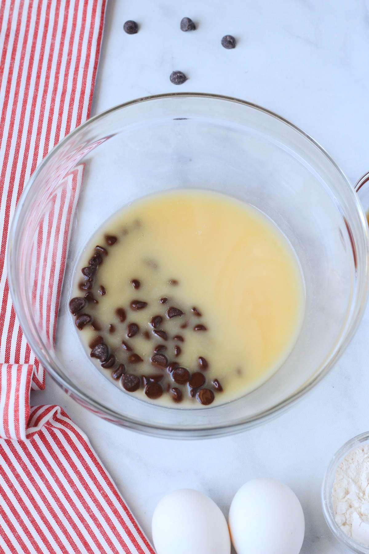 A glass bowl with dairy-free chocolate and vegan butter after melting.
