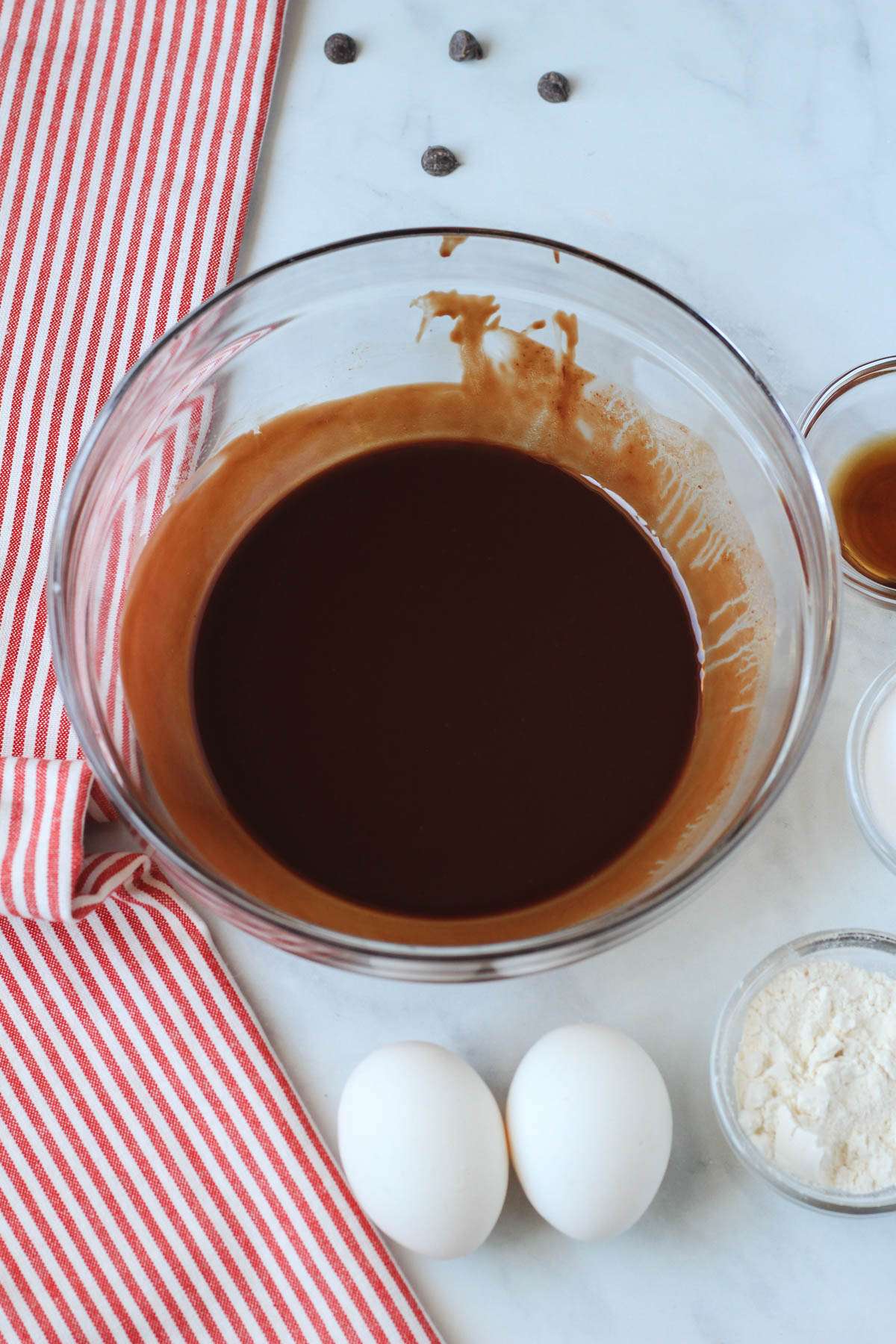 Melted dairy-free chocolate and vegan butter in a glass bowl.