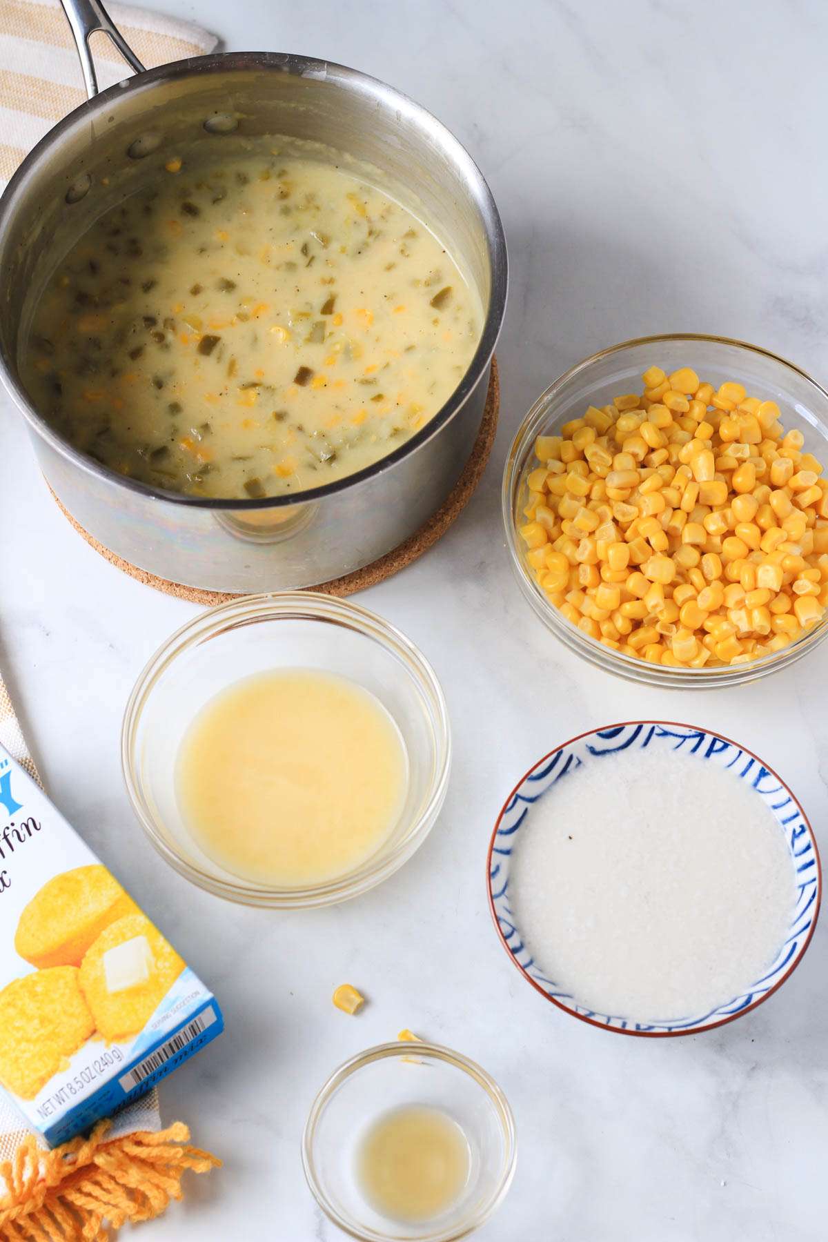 Ingredients for jalapeño corn casserole on a white counter.