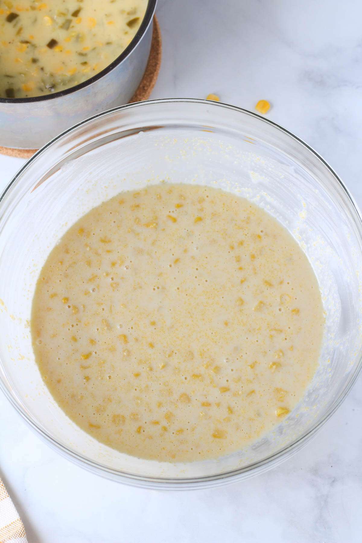 A mixing bowl with the corn casserole ingredients mixed together before adding the creamed corn.