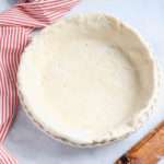 Vegan all-butter pie crust in a pie dish before baking.