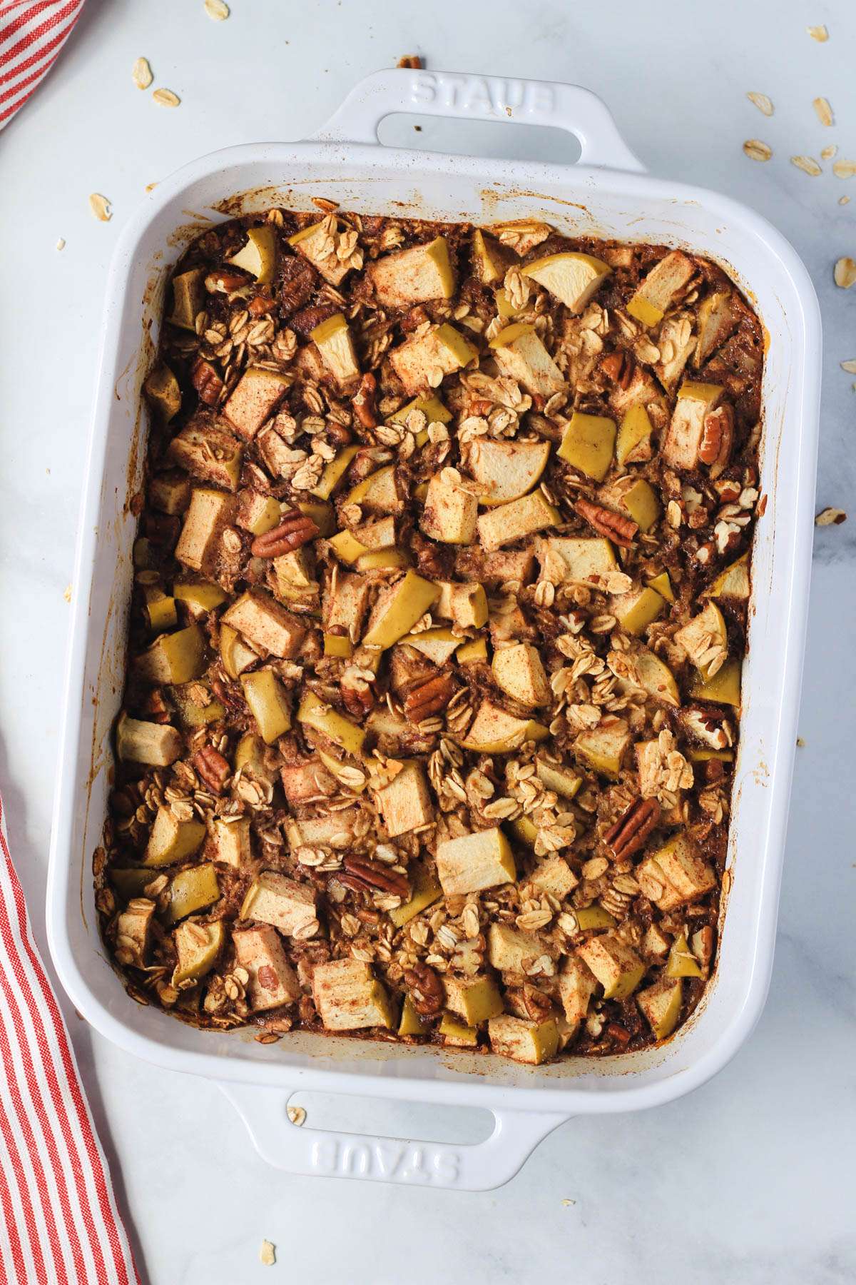 A white baking dish with apple pie baked oatmeal after baking.