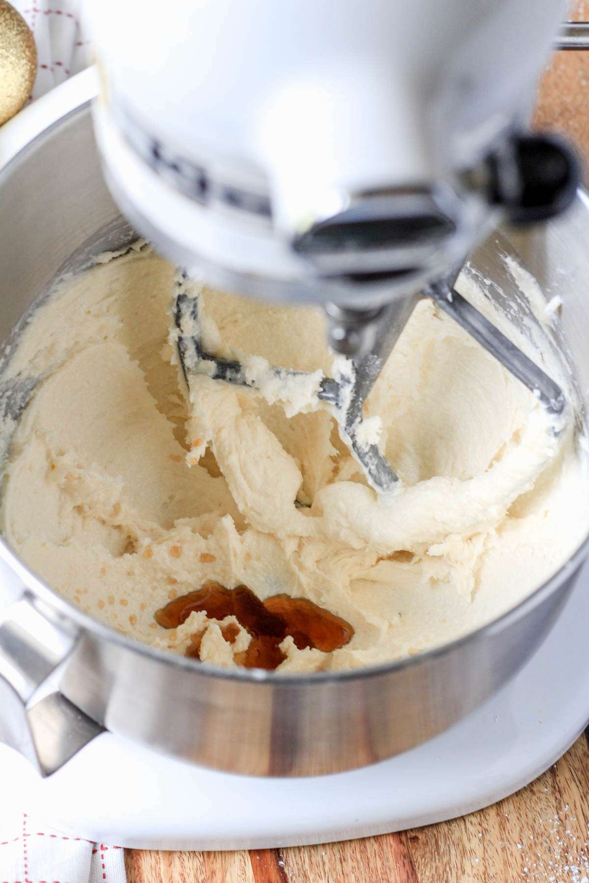 A mixing bowl with creamed vegan butter mixture topped with vanilla.