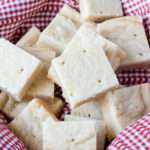 A close up of a pile of vegan shortbread in a white and red basket.