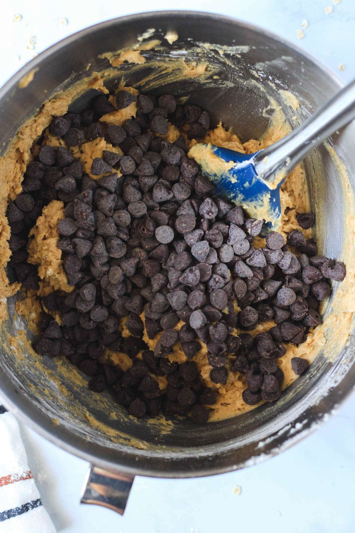 Chocolate chips on top of peanut butter oatmeal cookie dough.