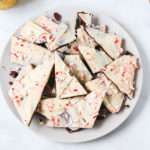 A white plate with vegan peppermint bark piled on top.