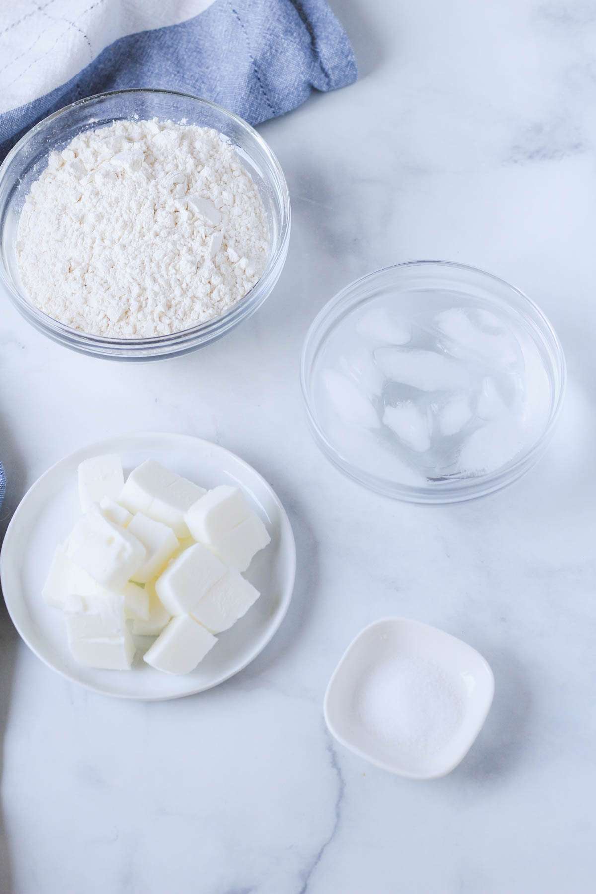 Ingredients for a classic crisco pie dough on a white counter.