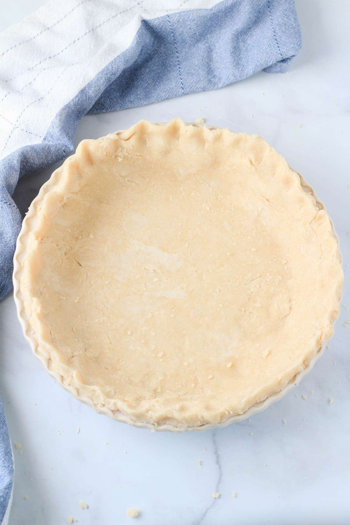 A pie pan with shortening pie crust before baking.