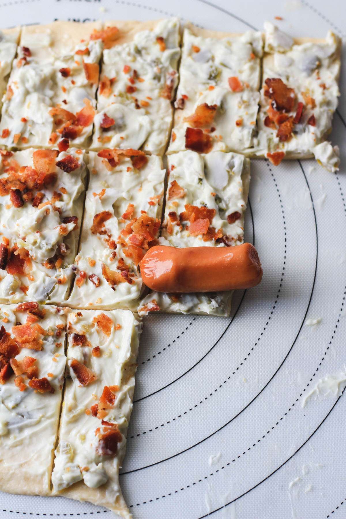 A little smokie on top of the crescent roll before rolling it up into the blanket.
