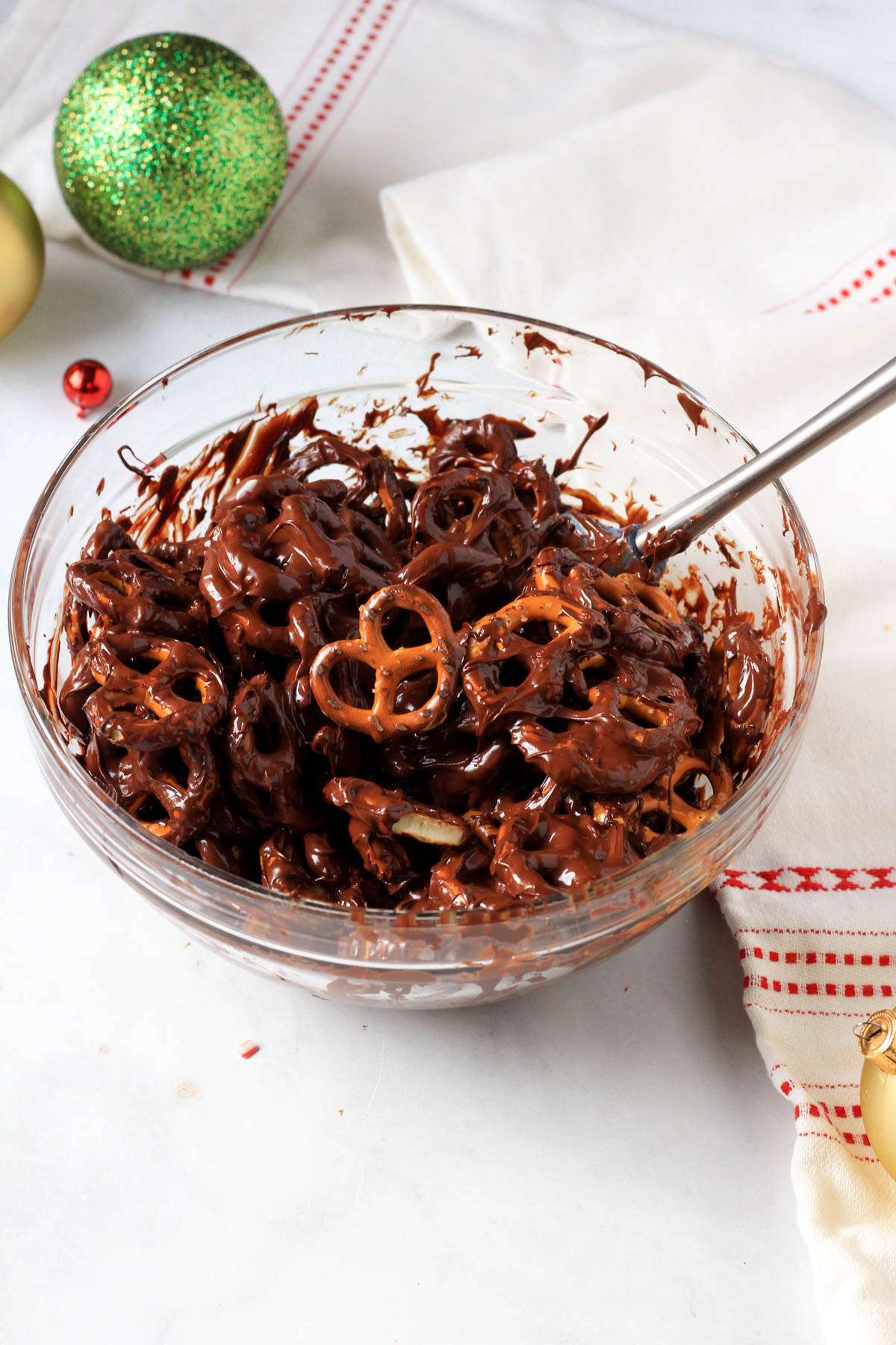A glass bowl with dairy-free chocolate after the pretzels have been added.