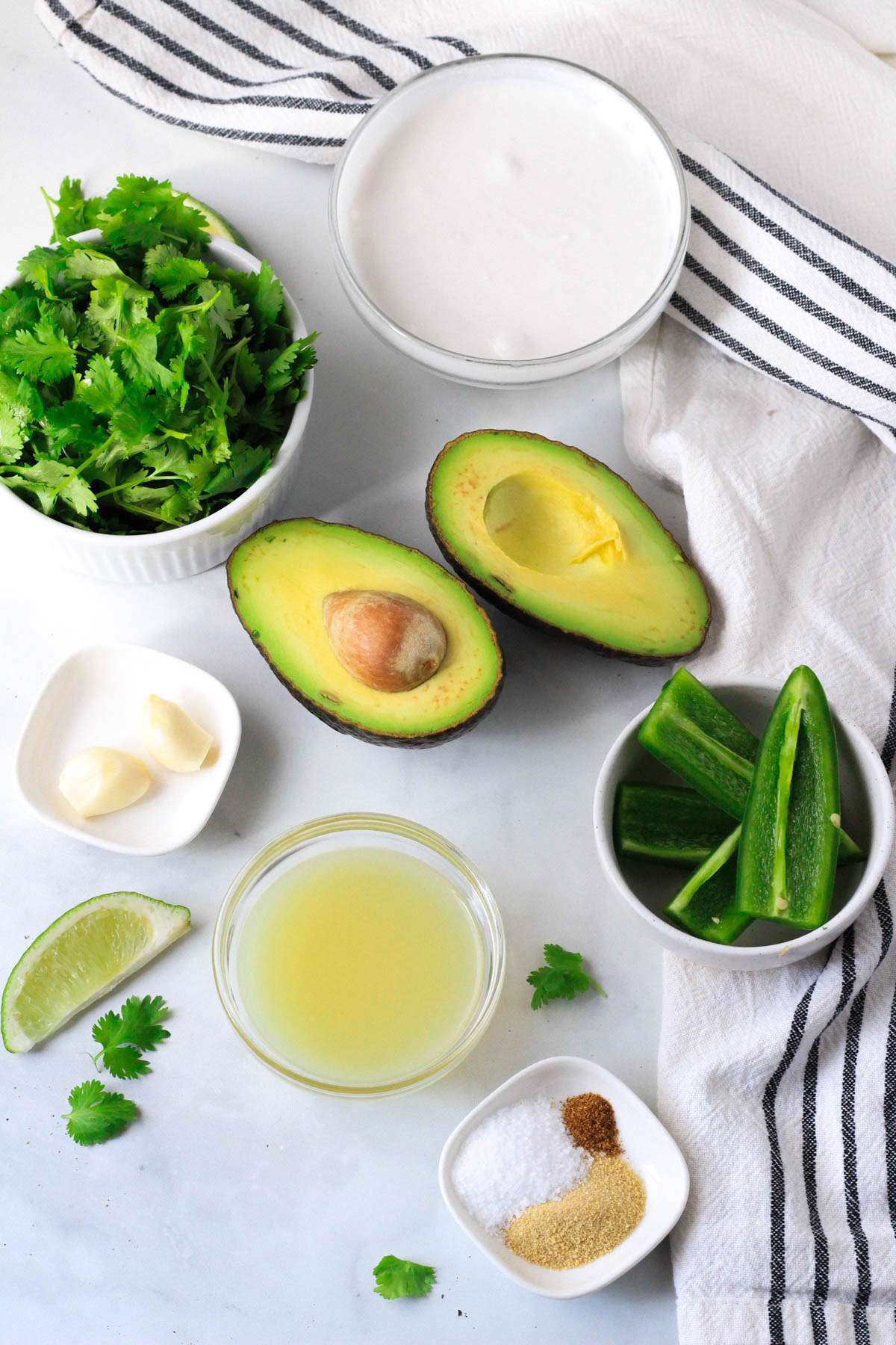 Ingredients for the avocado cilantro dressing on a white counter.
