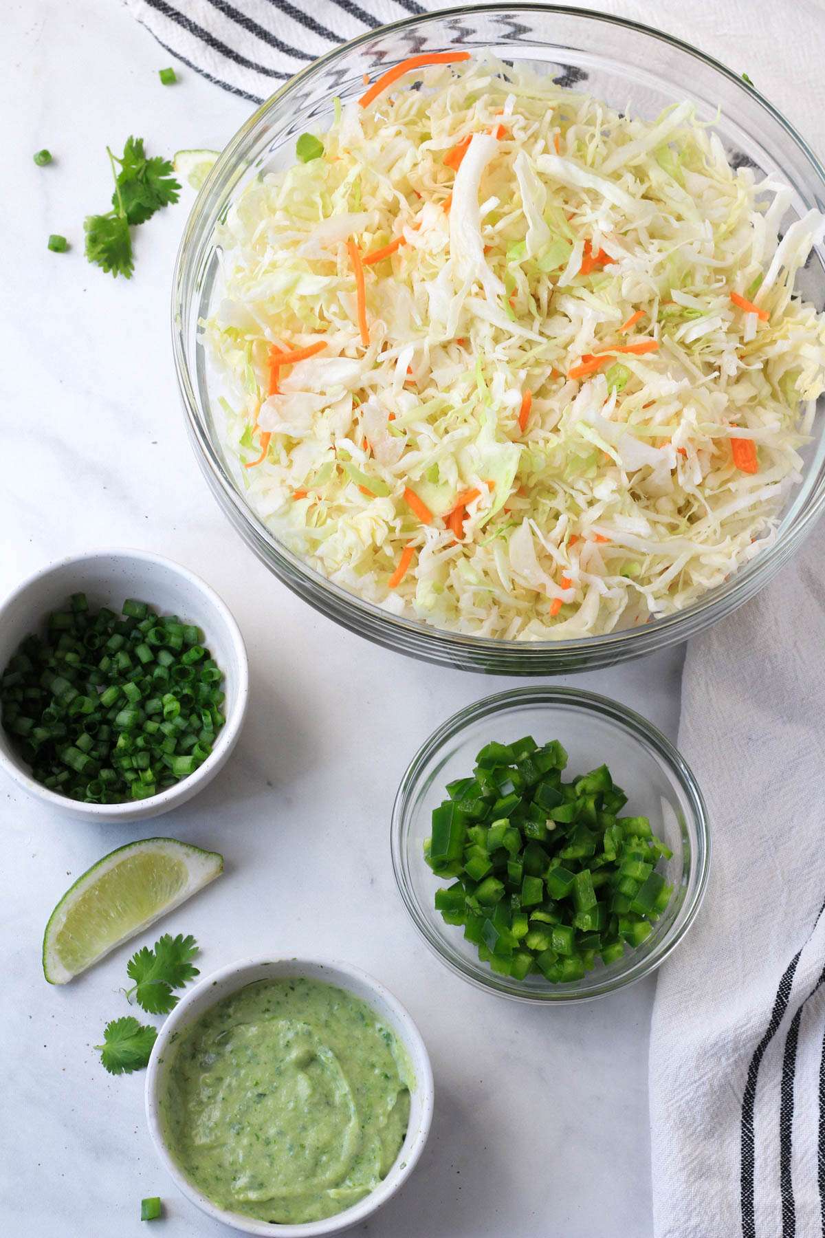 Ingredients for the jalapeño coleslaw on a white counter.