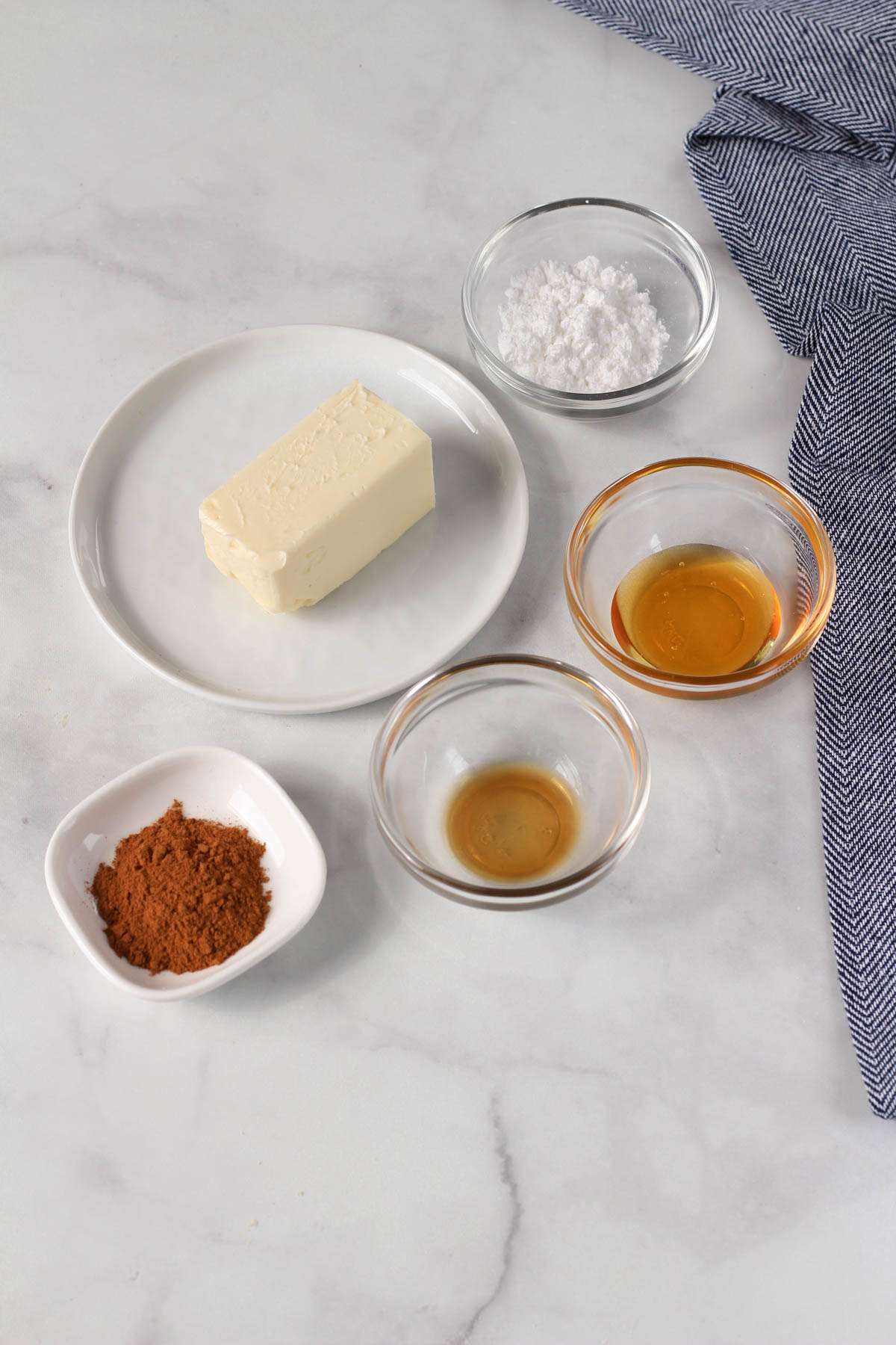 Ingredients for cinnamon honey butter on a white counter.