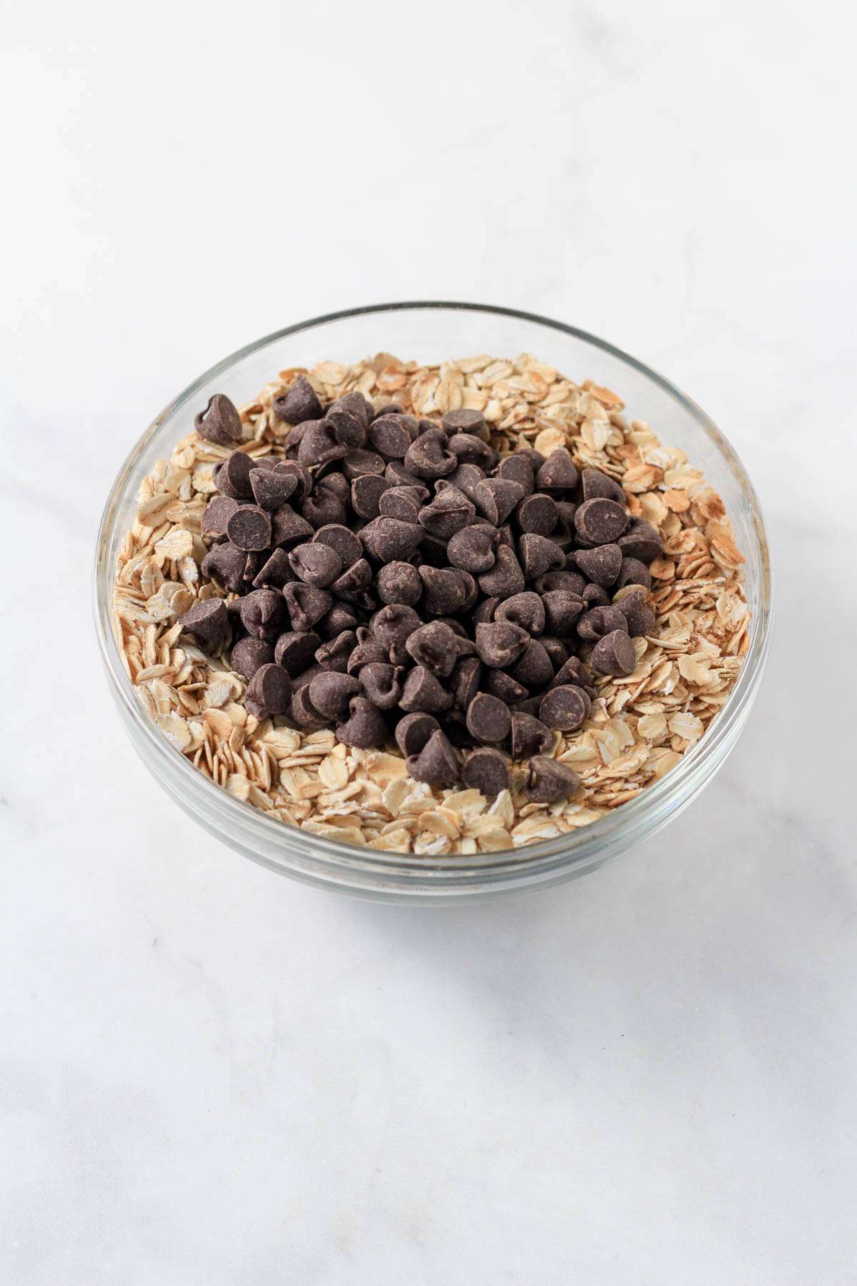 Dry ingredients for banana baked oatmeal in a small glass bowl.