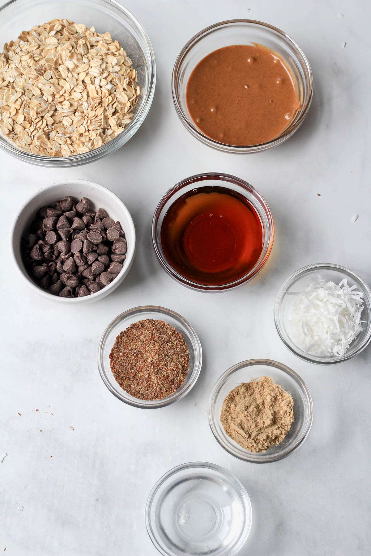 Ingredients for almond joy lactation bites on a white counter.