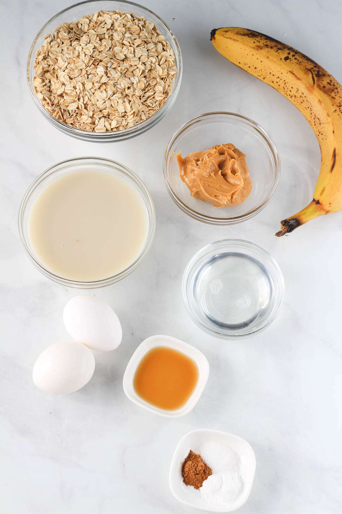 Ingredients for baked peanut butter oatmeal bars on a white counter.