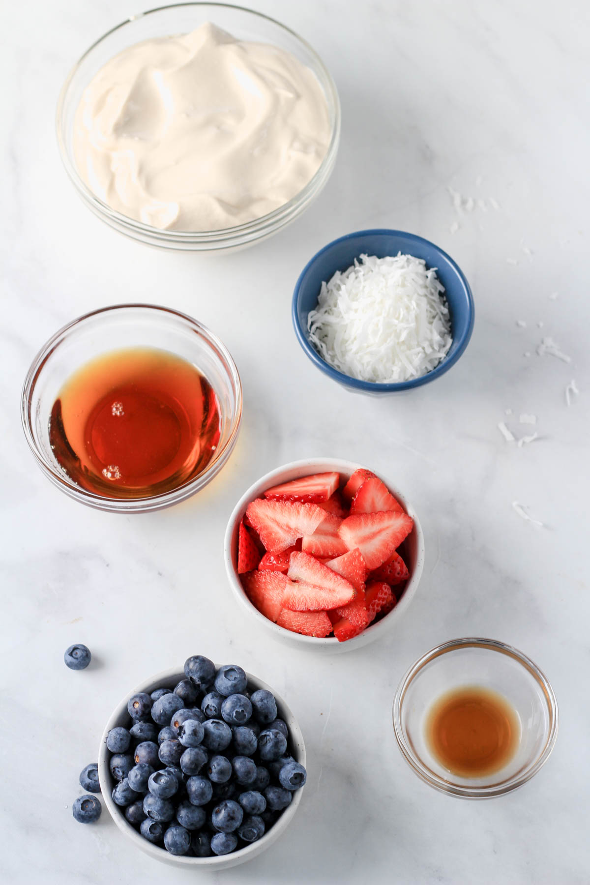 Ingredients for vegan frozen yogurt bark on a white counter.