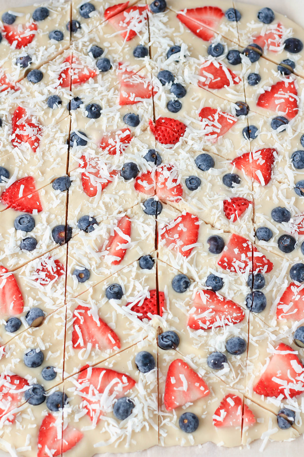 Sliced vegan frozen yogurt bark in a harringbone pattern on parchment paper.