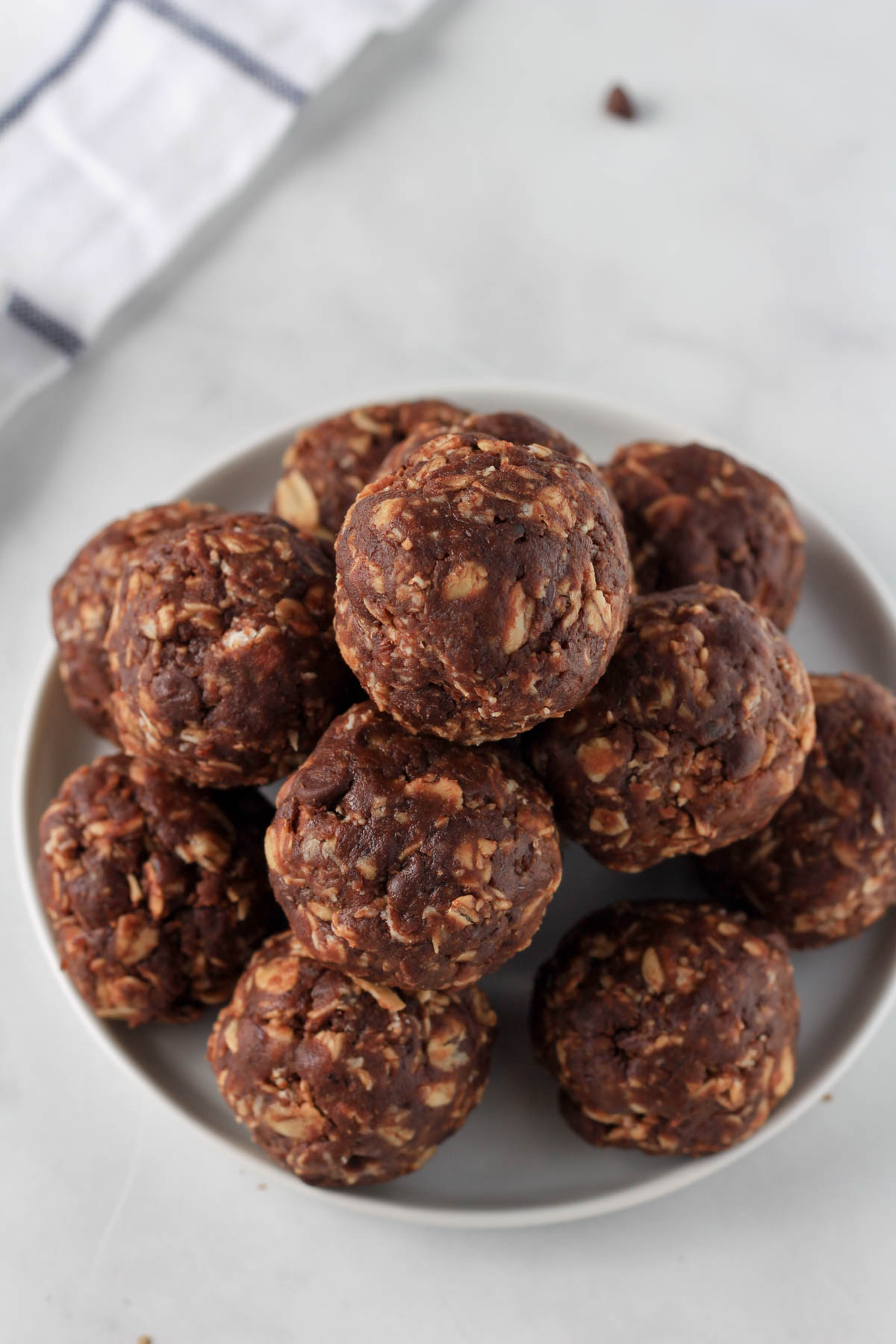 A small white plate piled high with vegan chocolate lactation bites.