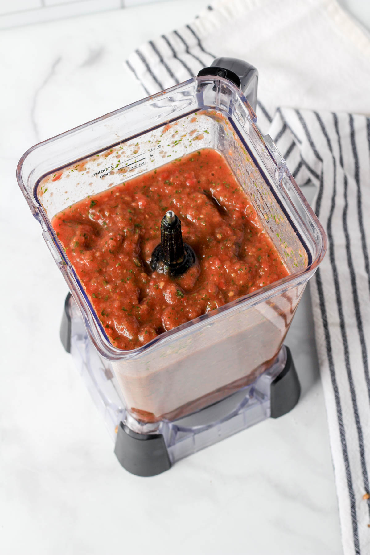 The top down view of a blender with salsa.