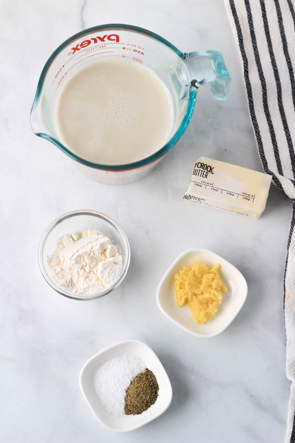 Top down picture of the ingredients for the garlic cream sauce.