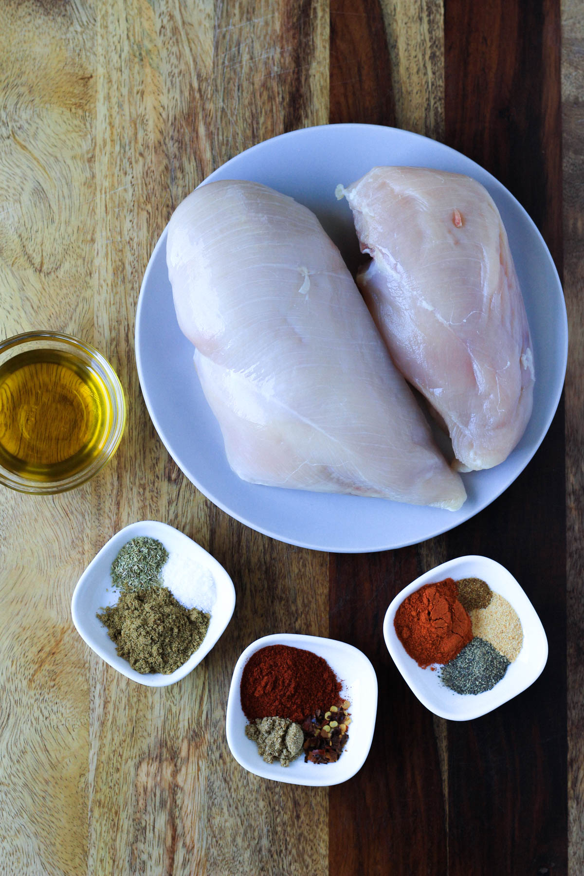 Ingredients for southwest chicken on a wooden cutting board.