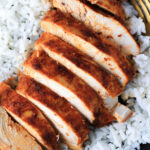 Oven baked southwest chicken breast sliced on top of rice.