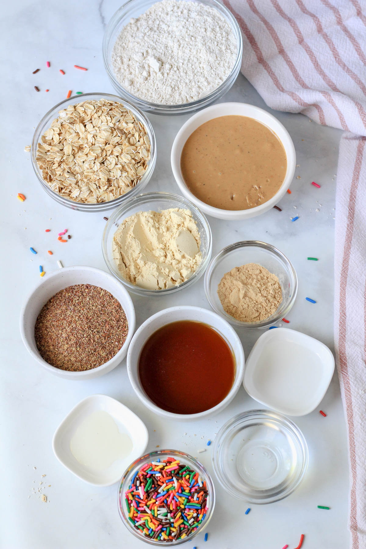 Ingredients for cake batter lactation bites on a white counter.
