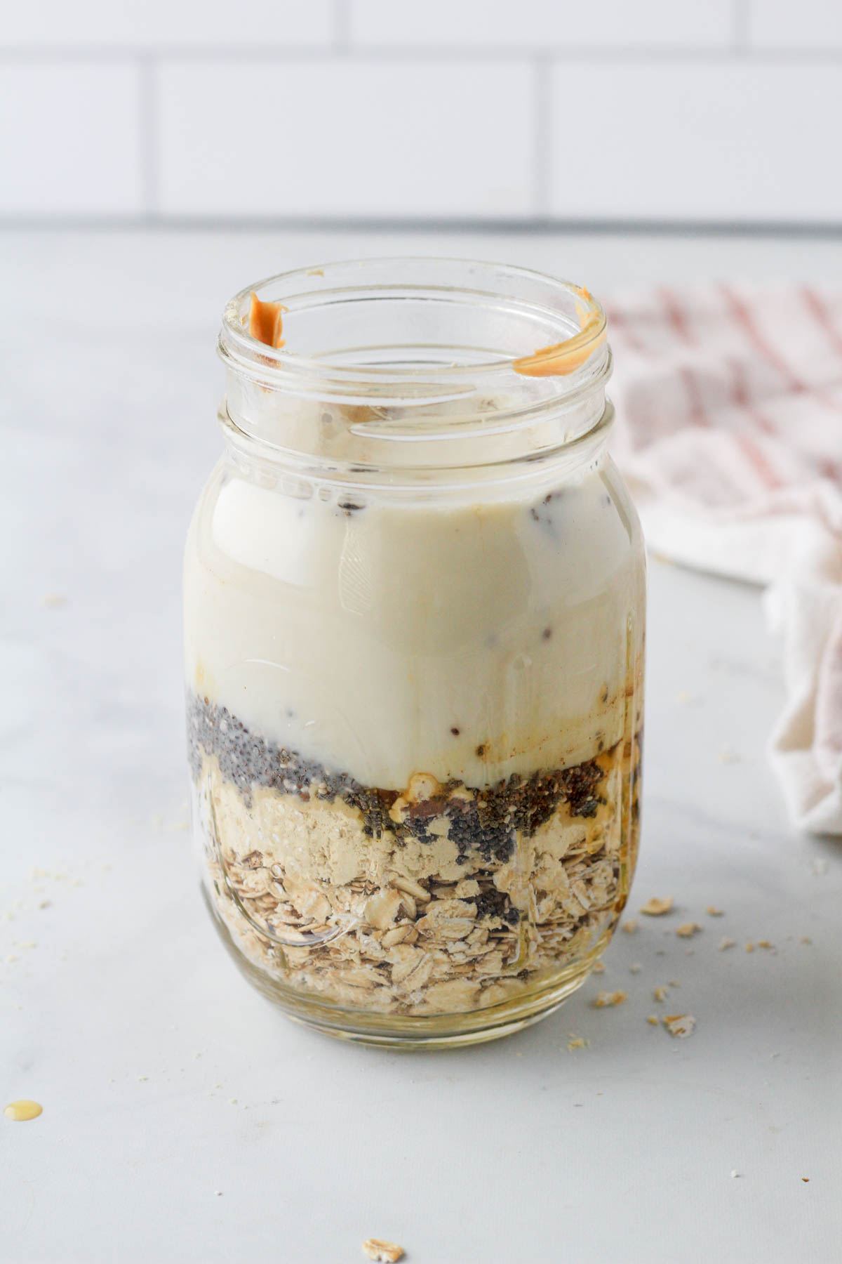 Dry ingredients at the bottom of a mason jar with the liquid ingredients on the top.
