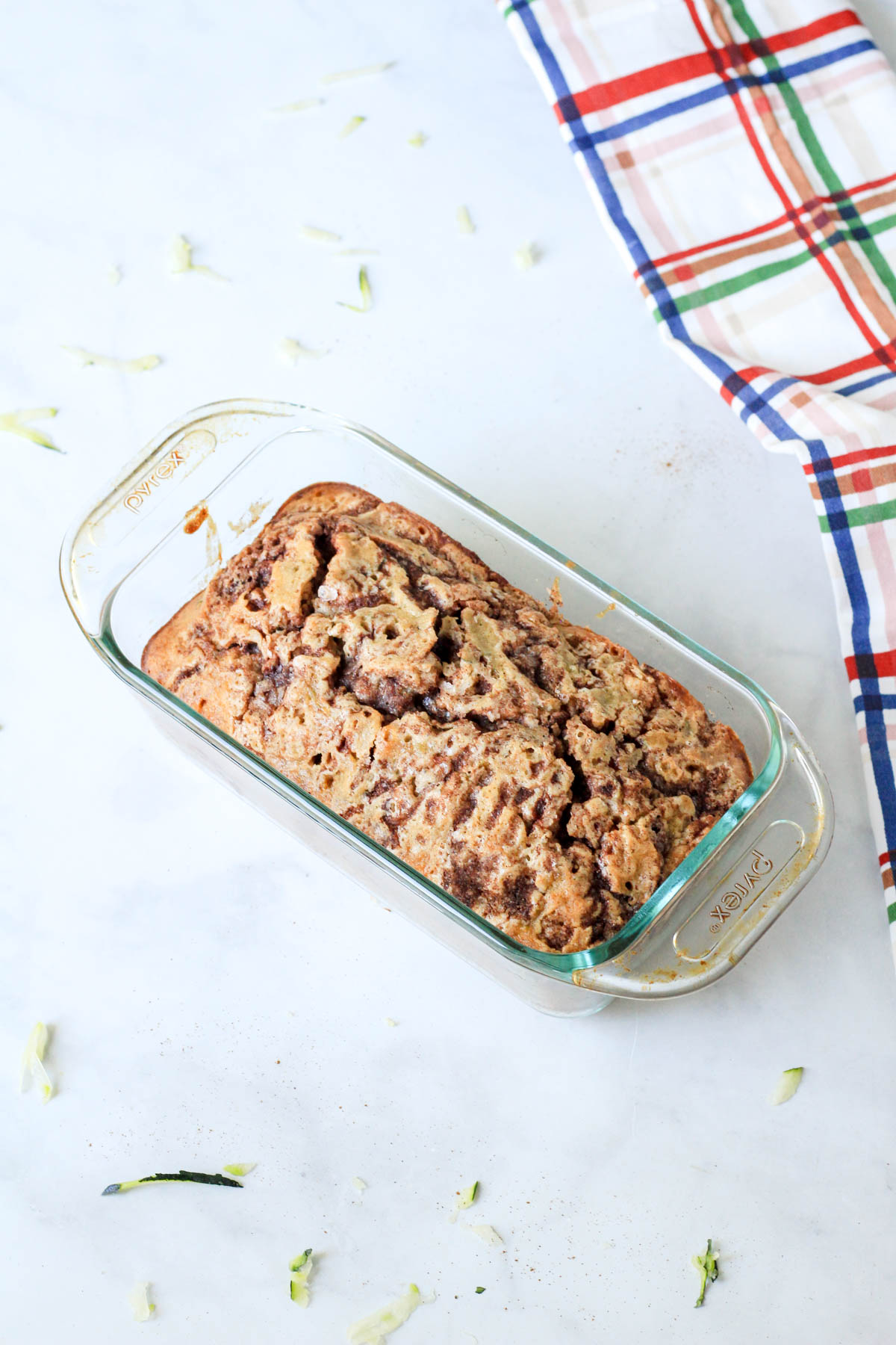A glass baking pan with cinnamon swirl zucchini bread after baking.