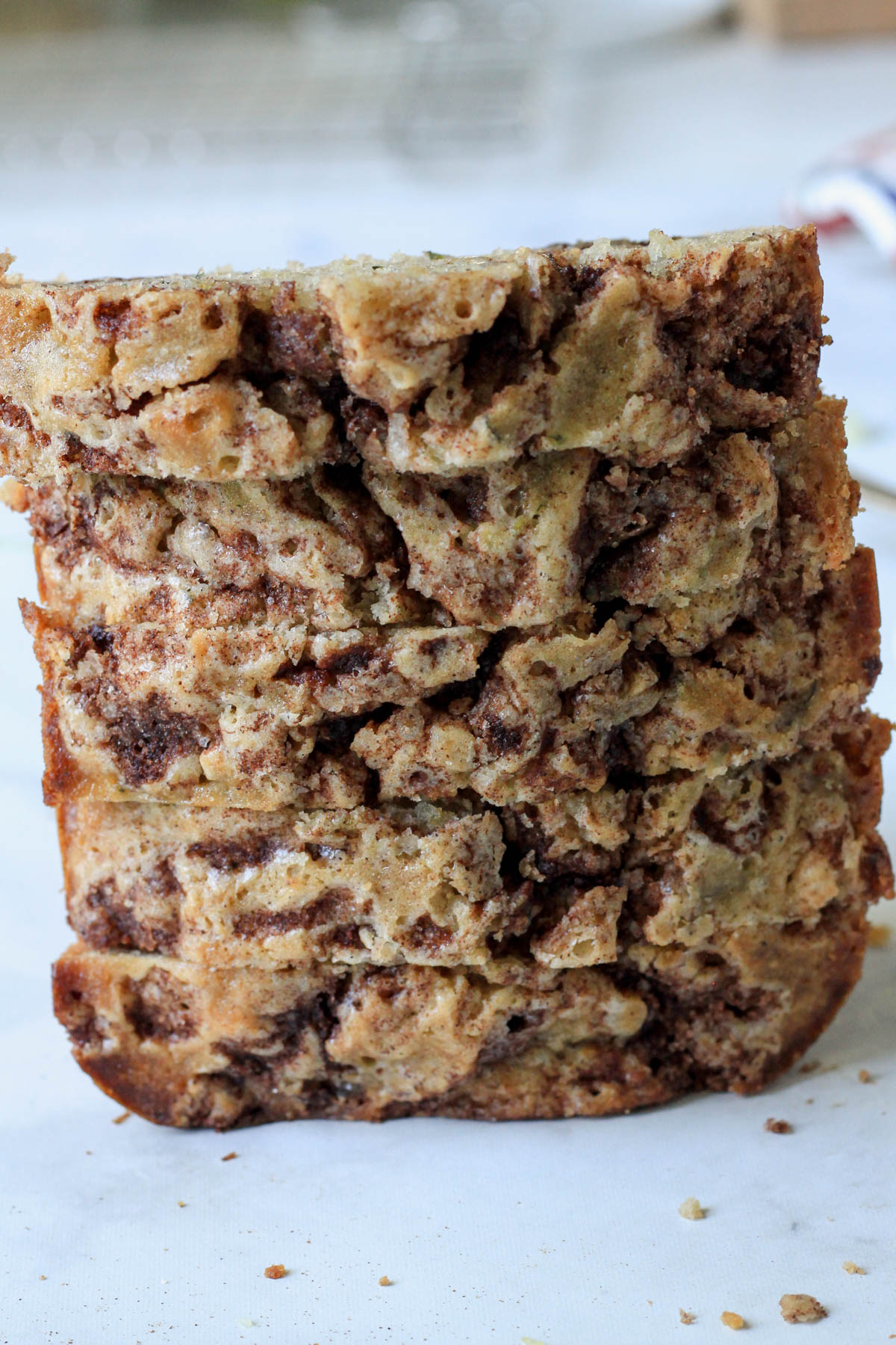 A stack of dairy-free zucchini bread stacked on top of a white counter.