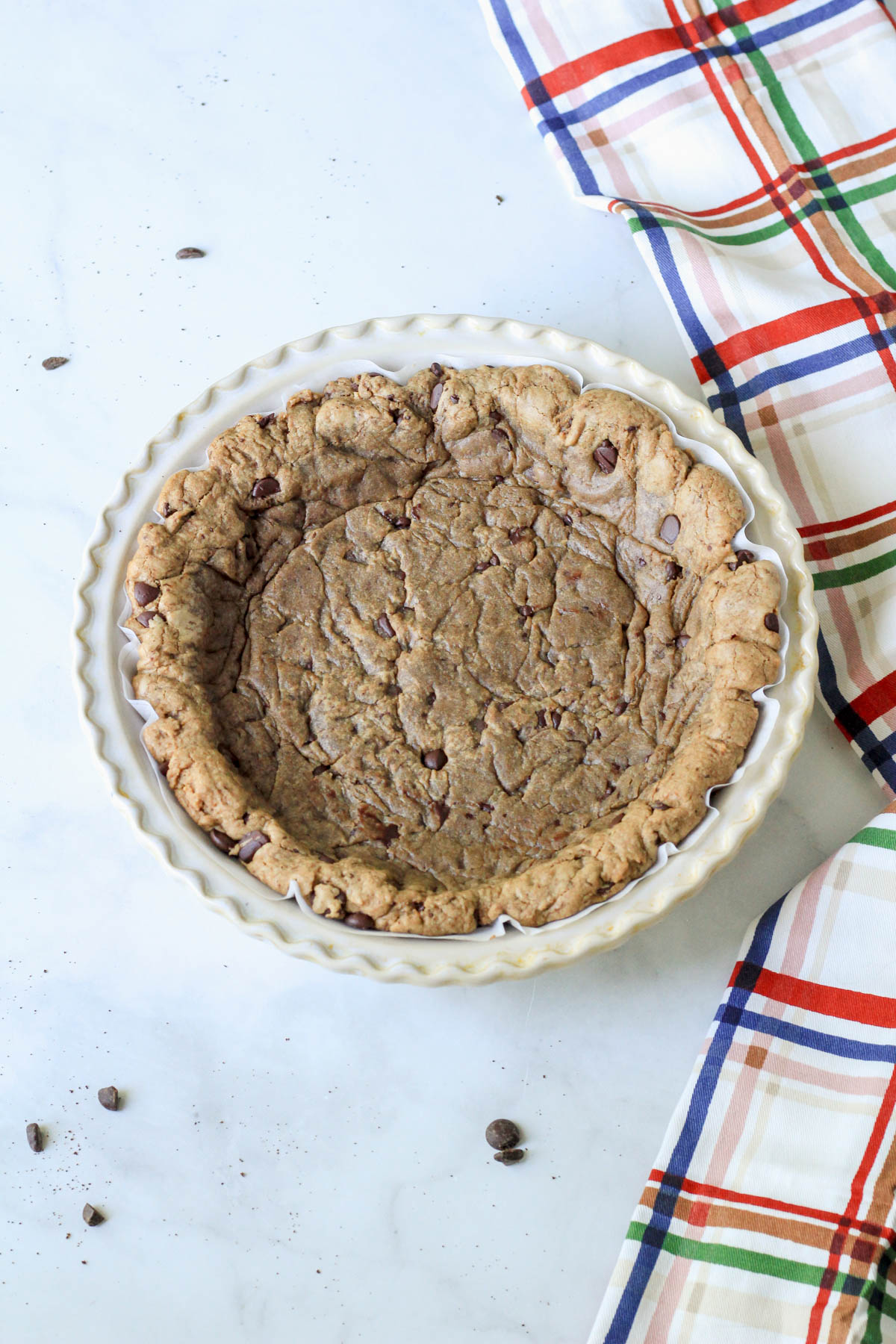 A 9-inch pie pan with baked espresso chocolate chip cookie crust.