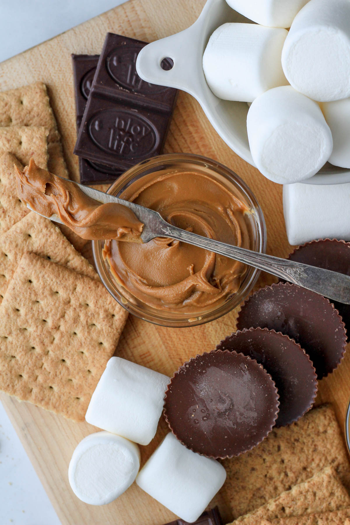 A small bowl of cookie butter in the middle of a dairy-free s'mores board.