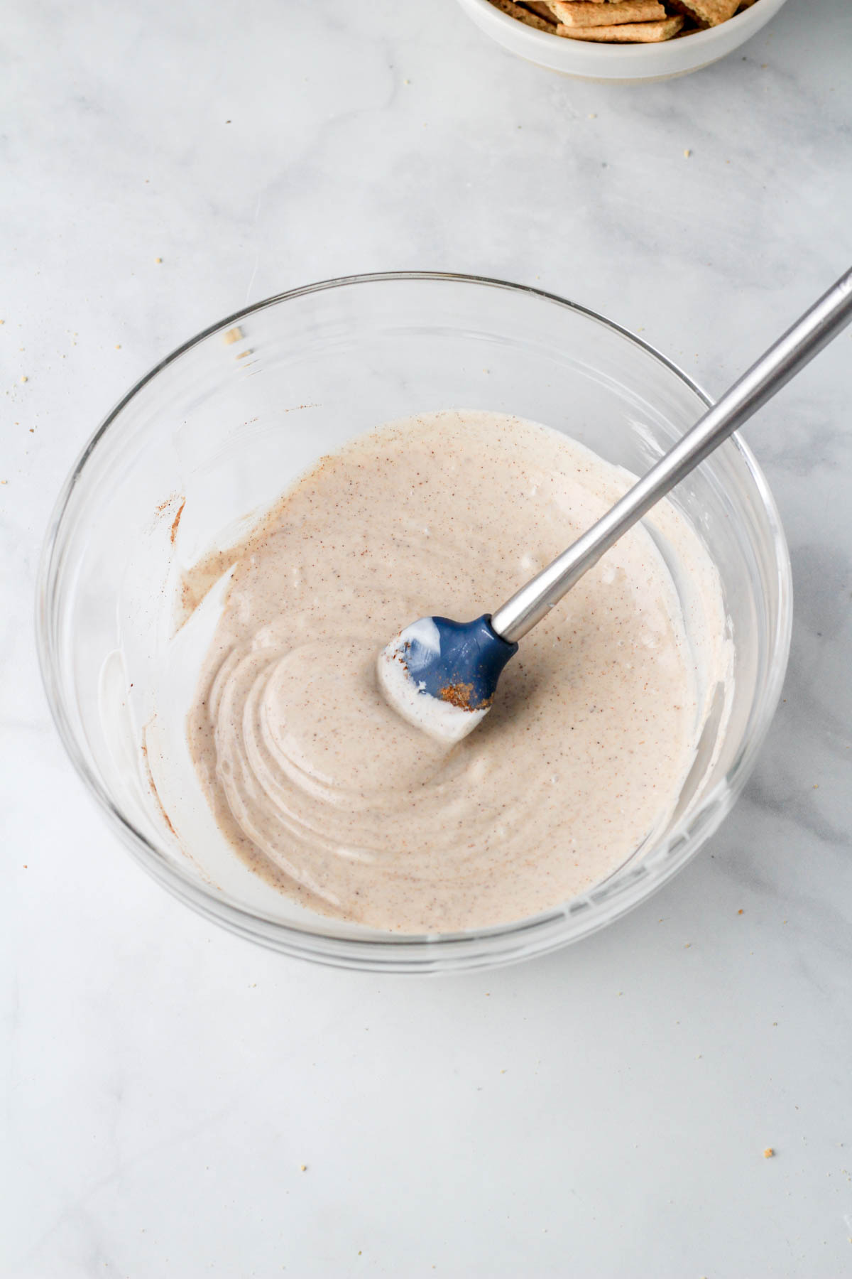 A large glass bowl with pumpkin pie spice flavored white chocolate.