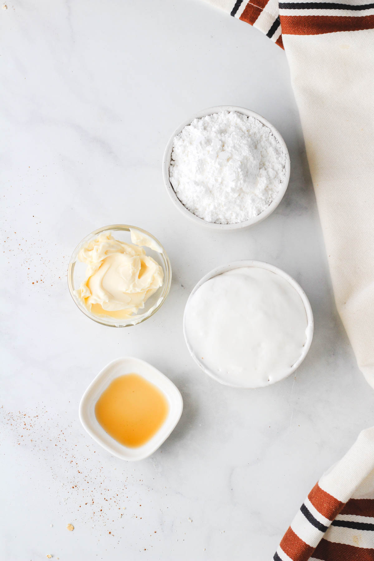 Ingredients for marshmallow fluff icing on a white counter.